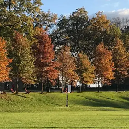 View of Grey Towers Castle in the Fall with a student walking.