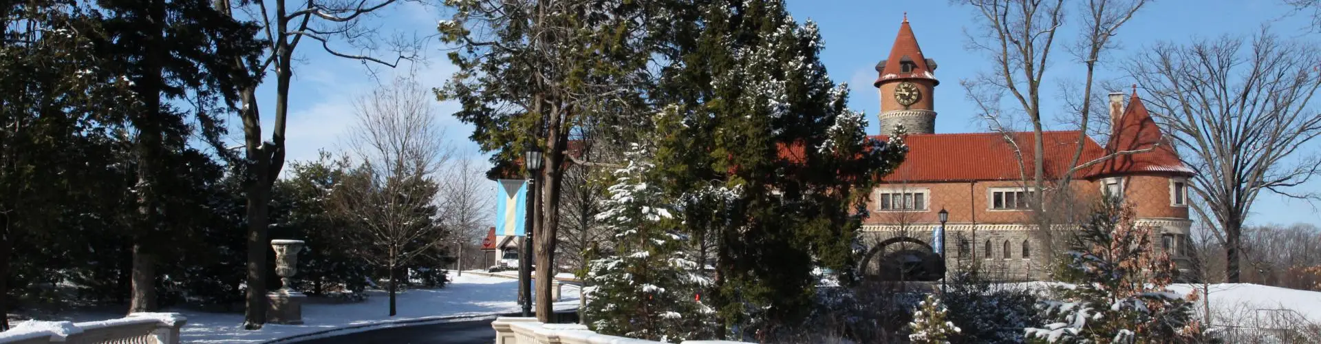 Photo of Murphy Hall with snow covered trees and grass.