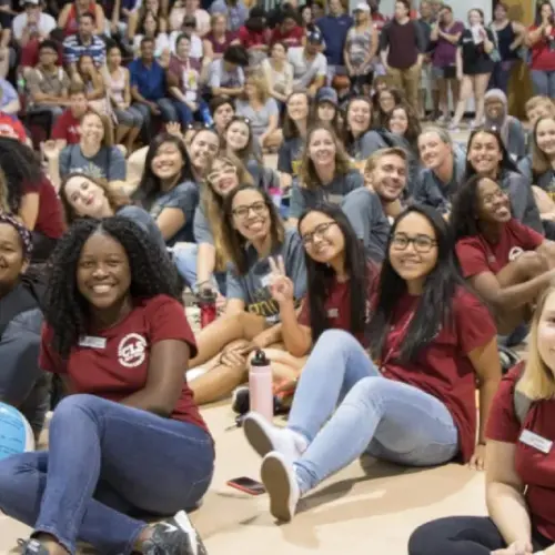 The gym filled with students with orientation leaders in the front of the picture.