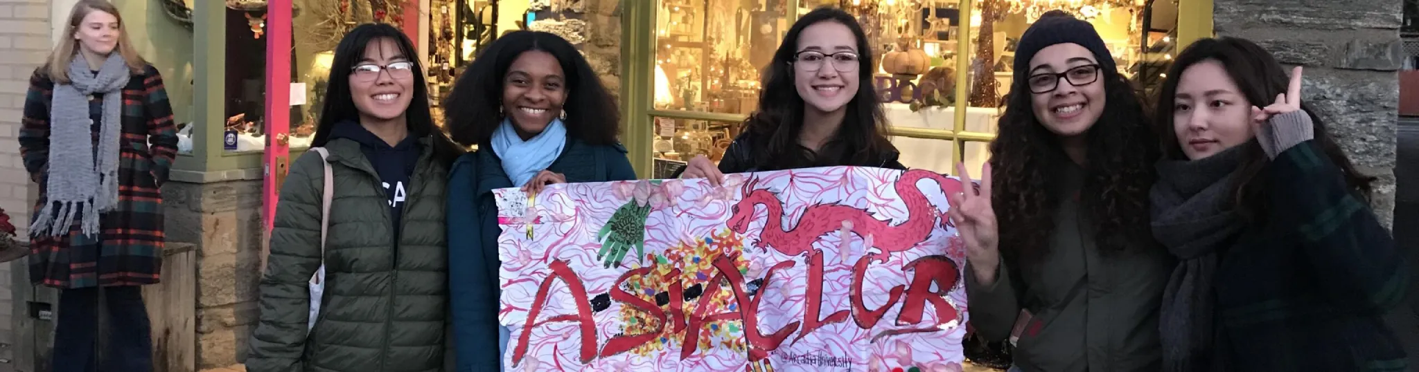Students holding a poster celebrating Asian culture