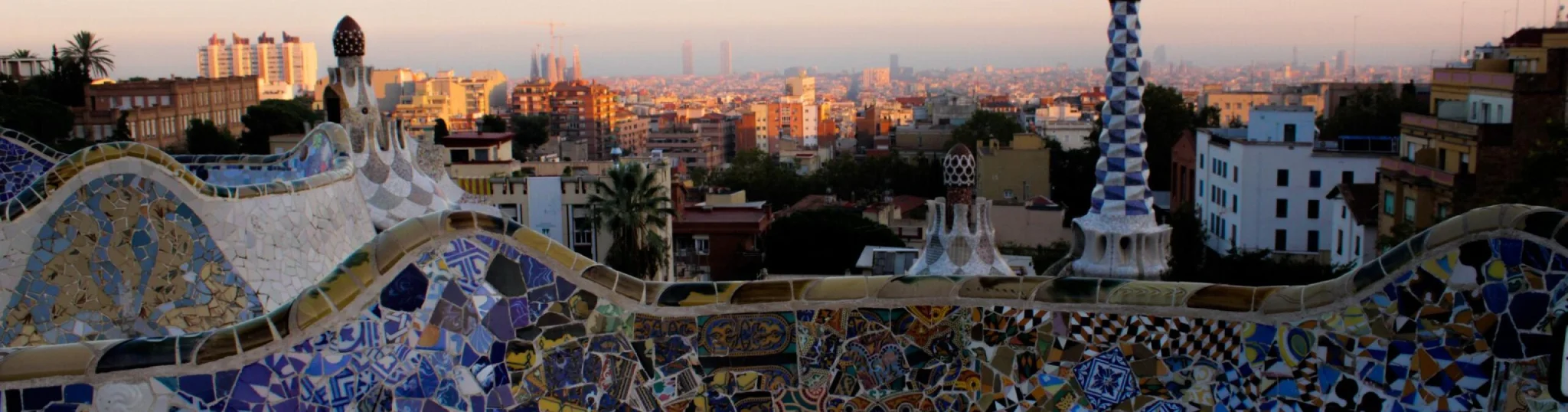 A look at a multi-colored wall with class and tile with a city in the background