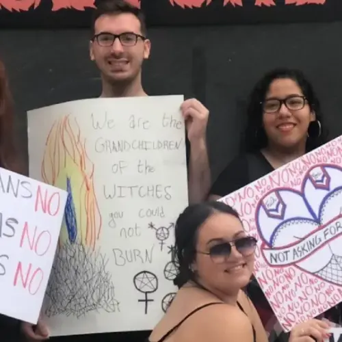 A group holding signs in support of feminism