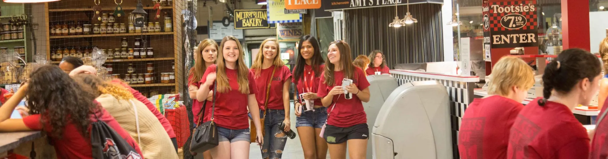 Students wearing red Class of 2021 t-shirts inside Reading Terminal Market