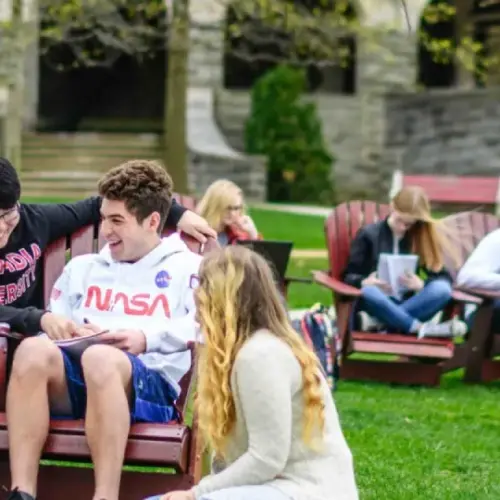 Students sitting down on the chairs outside of Grey Towers Castle