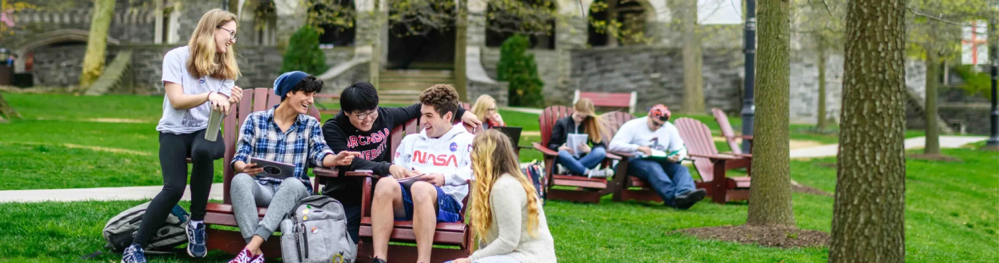 Students sitting down on the chairs outside of Grey Towers Castle