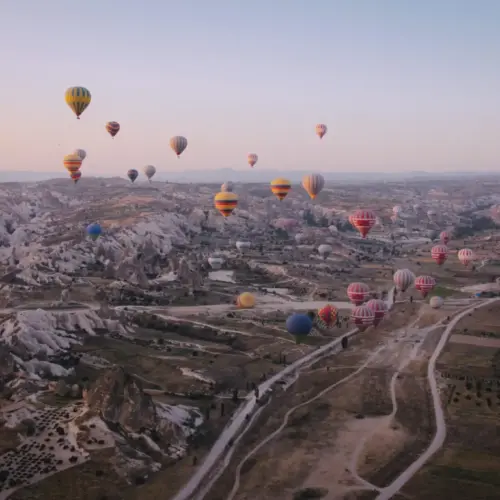 hot air balloons floating over mountains