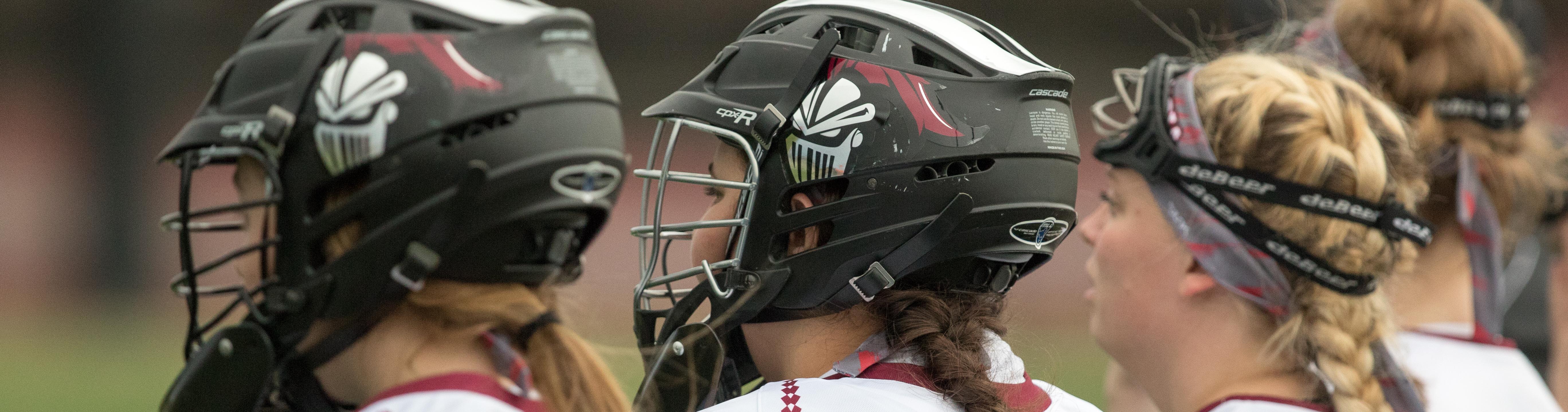 Closeup of women's lacrosse players in helmets