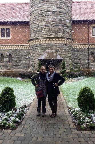 Two people posing together on a snowy day in Murphy Hall courtyard.