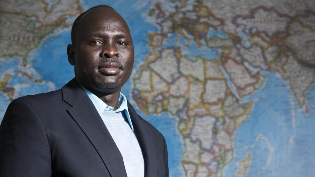 IPCR student Ayuen Ajok '11 poses in front of a map