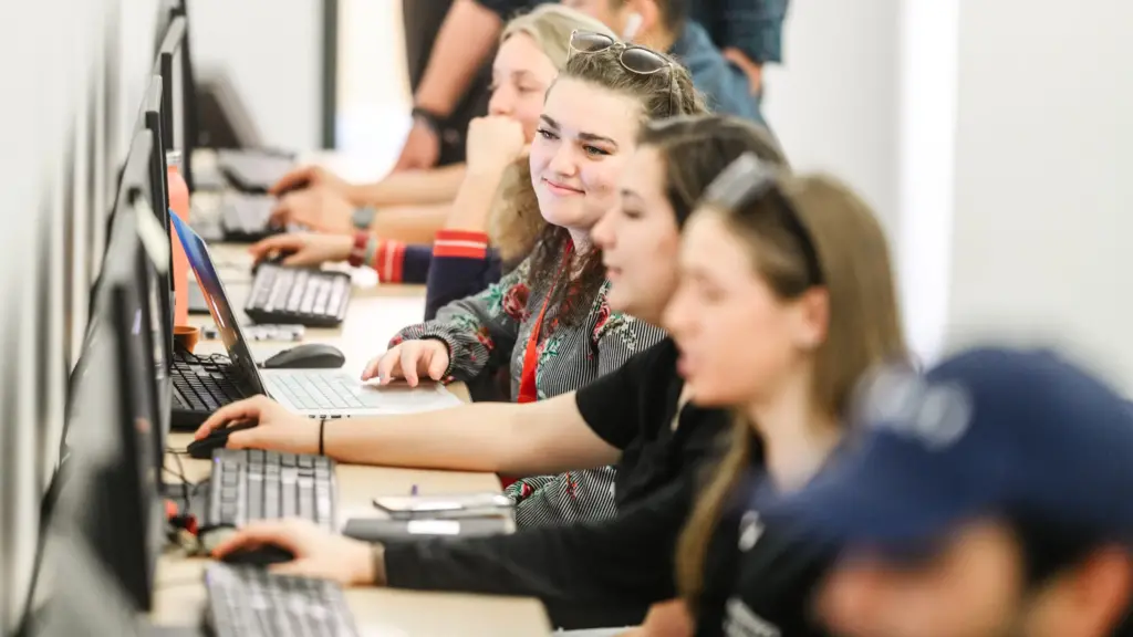 Communications students sit in a computer lab.