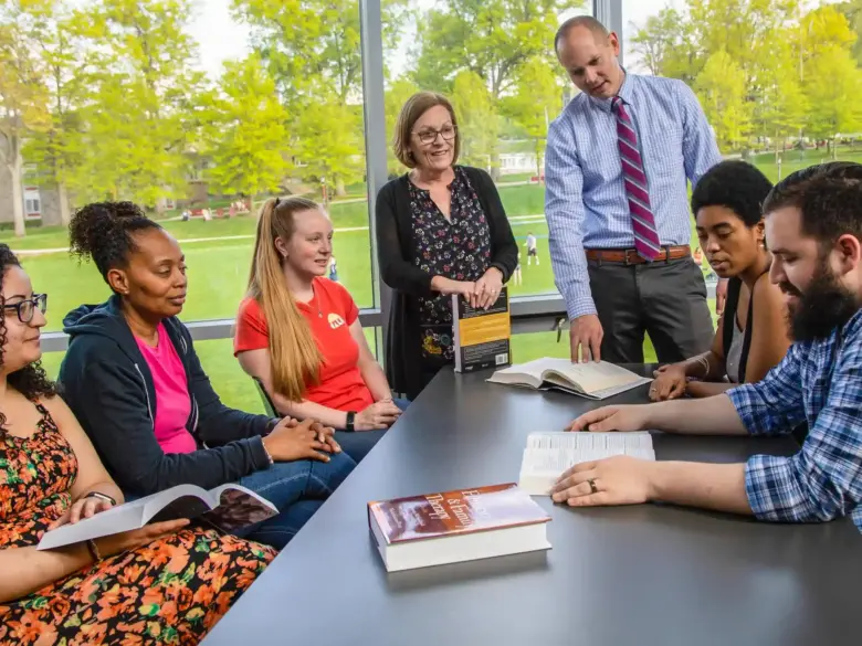 Counseling students and teachers have a discussion.