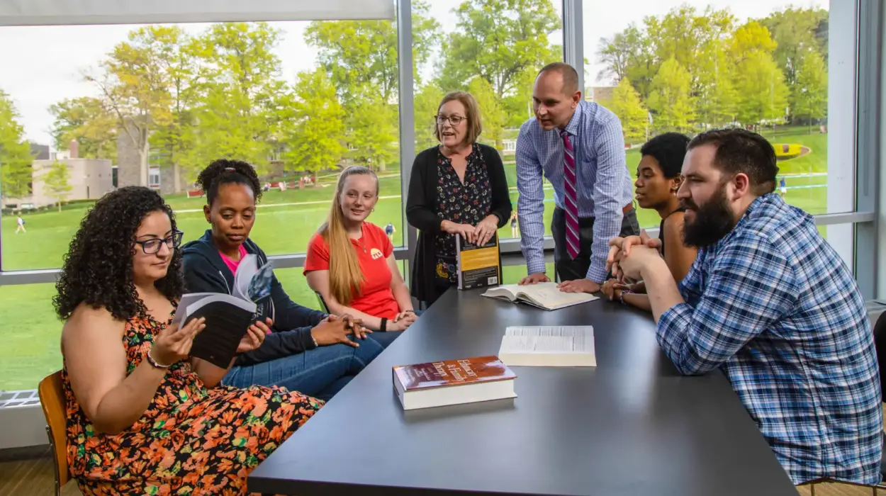 Counseling students discuss topics with professors.