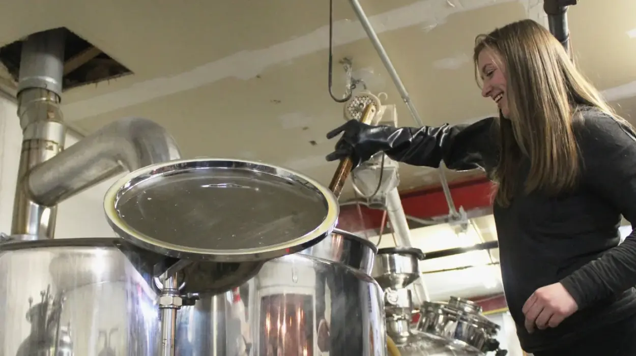 A student examines craft beer at a distillery.