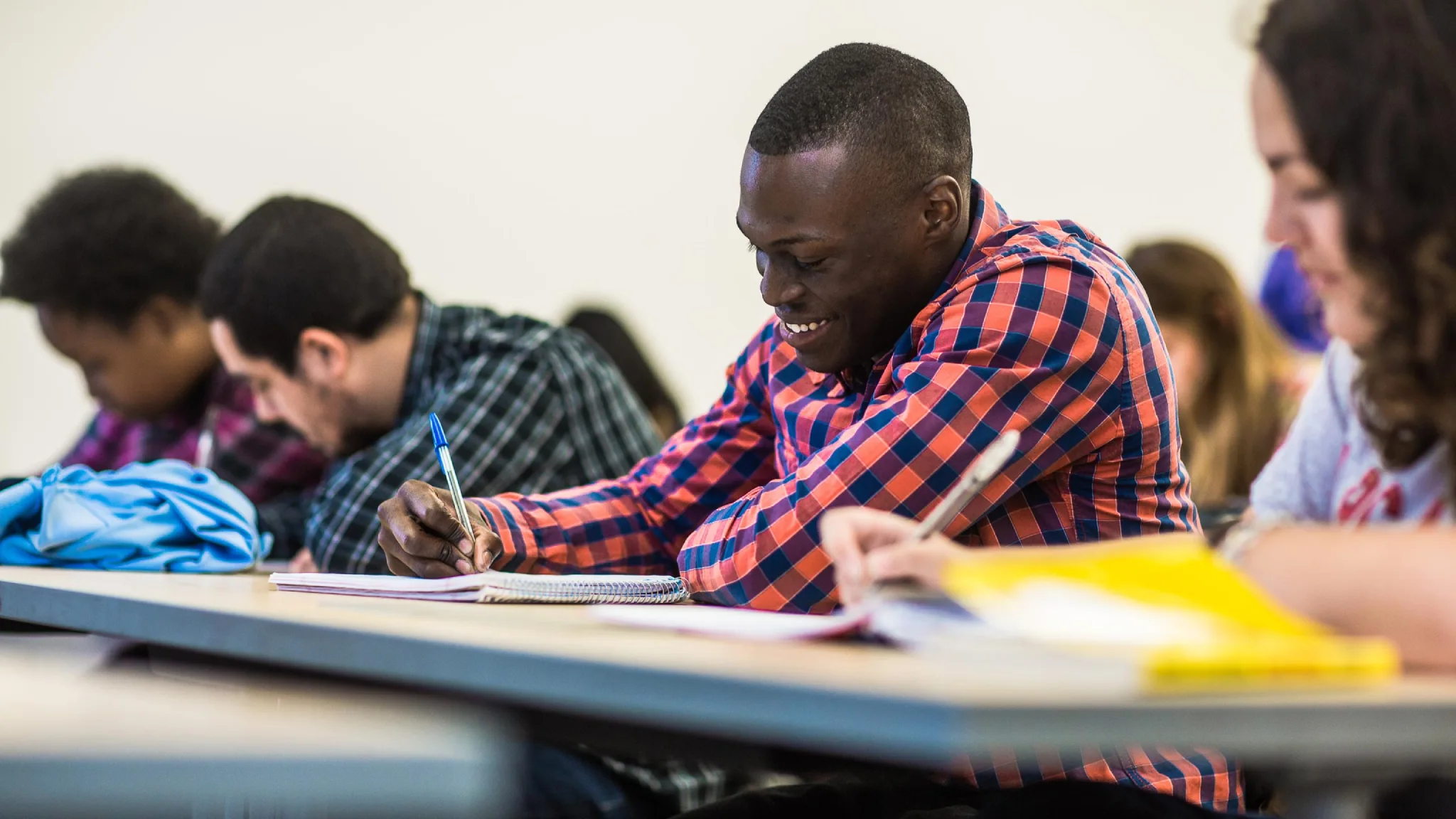 A student takes notes in a Spanish class at Arcadia University.