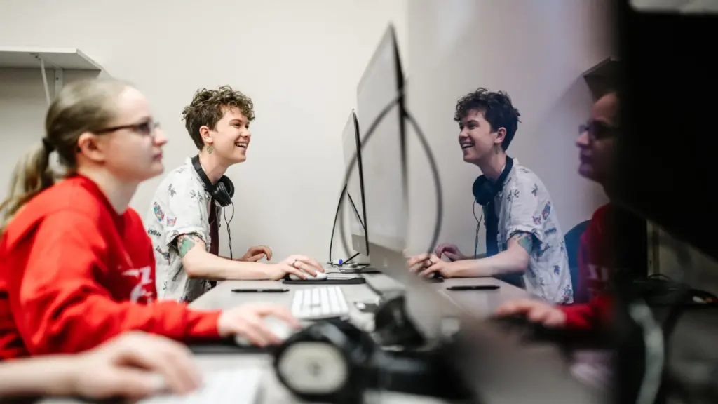 Two students work in a computer lab.