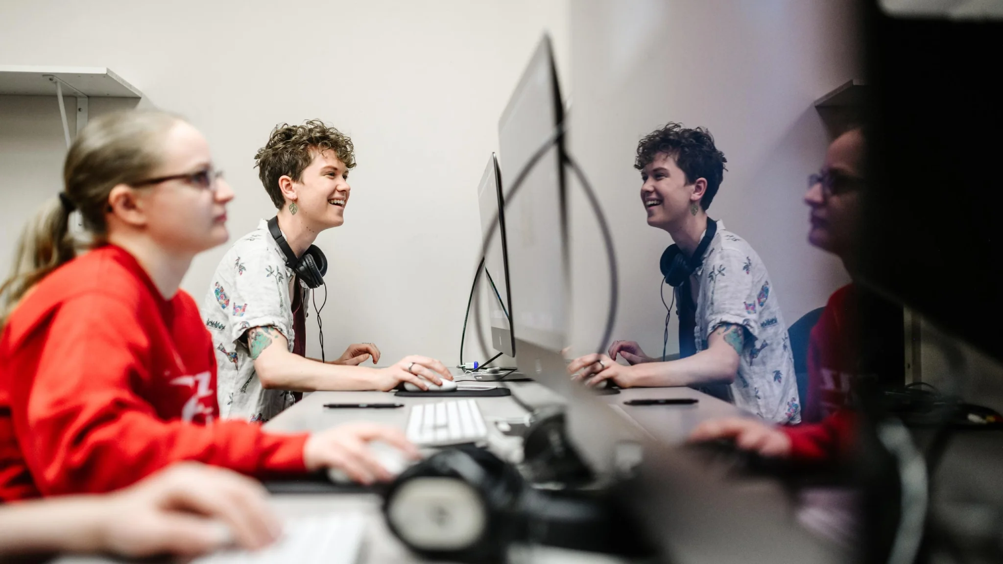 Two students work in a computer lab.