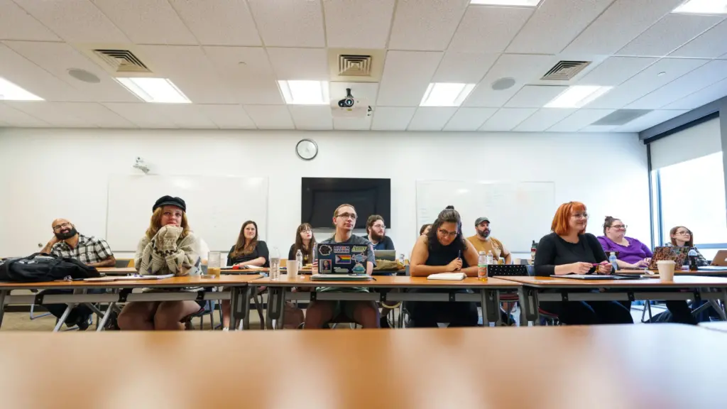 Students in the MFA Residency program listen to a lecture.