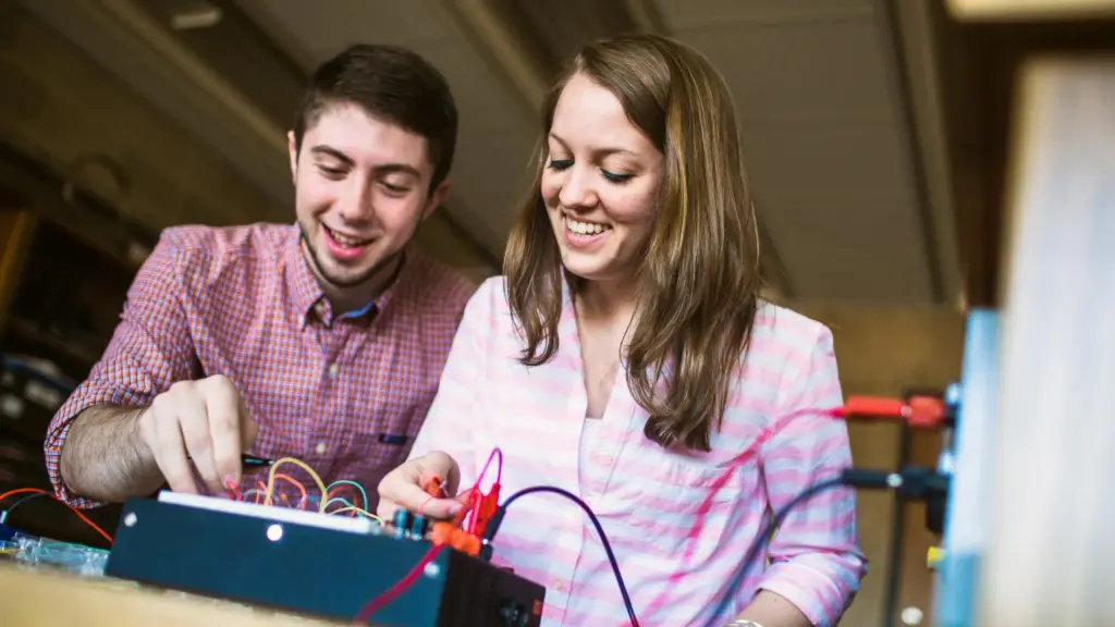 Students work on a circuit board in class.