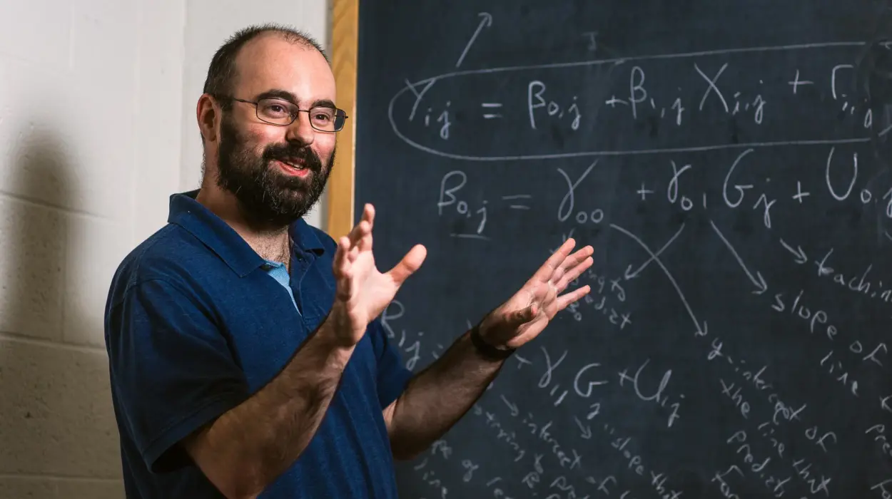 Professor lectures in front of a chalkboard