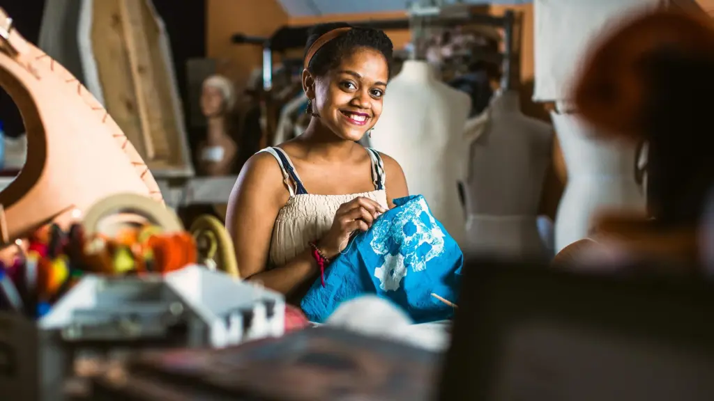 Student sews a costume in the theater arts program.