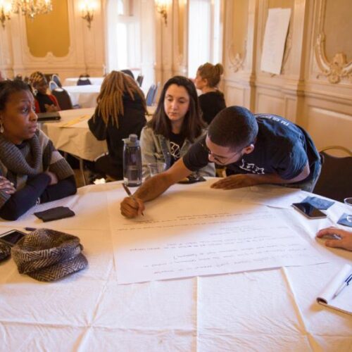 Students writing on poster boards in Grey Towers Castle