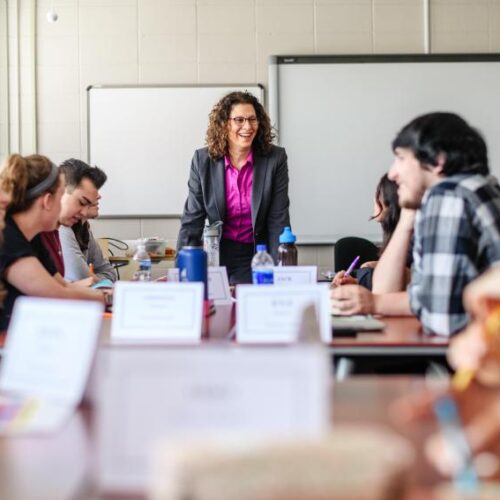 A professor talking to the class of students.