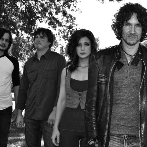 A rock band photo in greyscale.