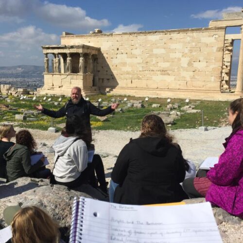 A guide teaches students in Greece