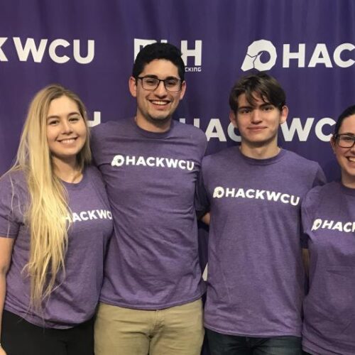 Four Arcadia students pose at the Hackathon Competition.
