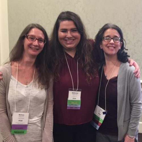 Faculty member with students at a conference.