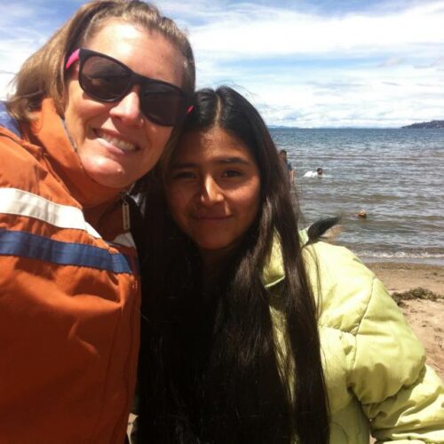 An adult and child taking a picture together in Peru.