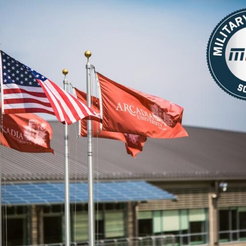 Military Friendly school 2017 logo imposed on a view of U.S. and Arcadia University flags