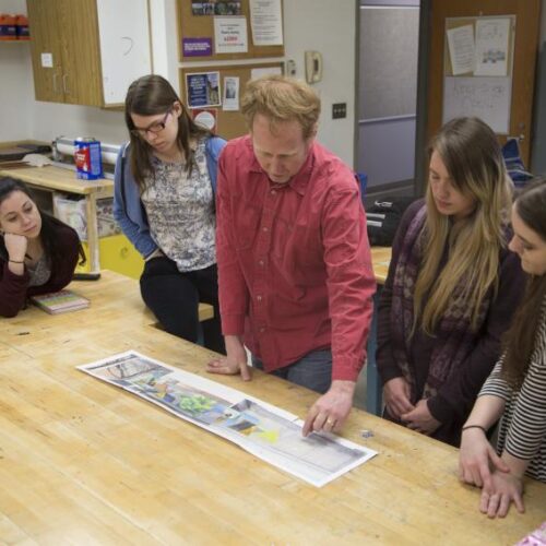 David Guinn shows students a plan for a public art mural