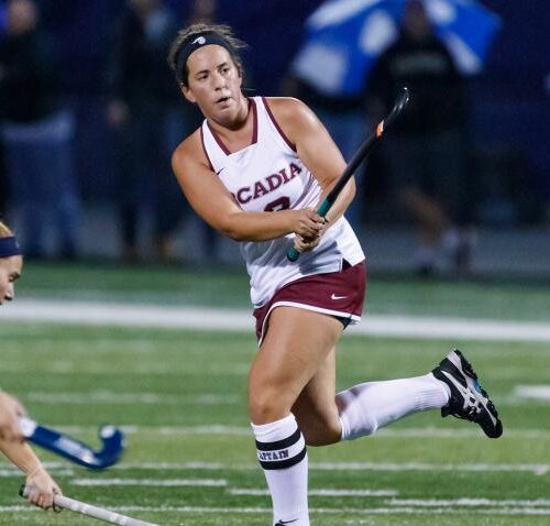 Arcadia women's field hockey player playing a game.