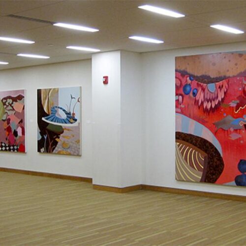 Different colorful art pieces in a gallery.