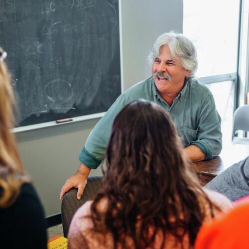 Dr. Morra smiling at his students during a lecture.