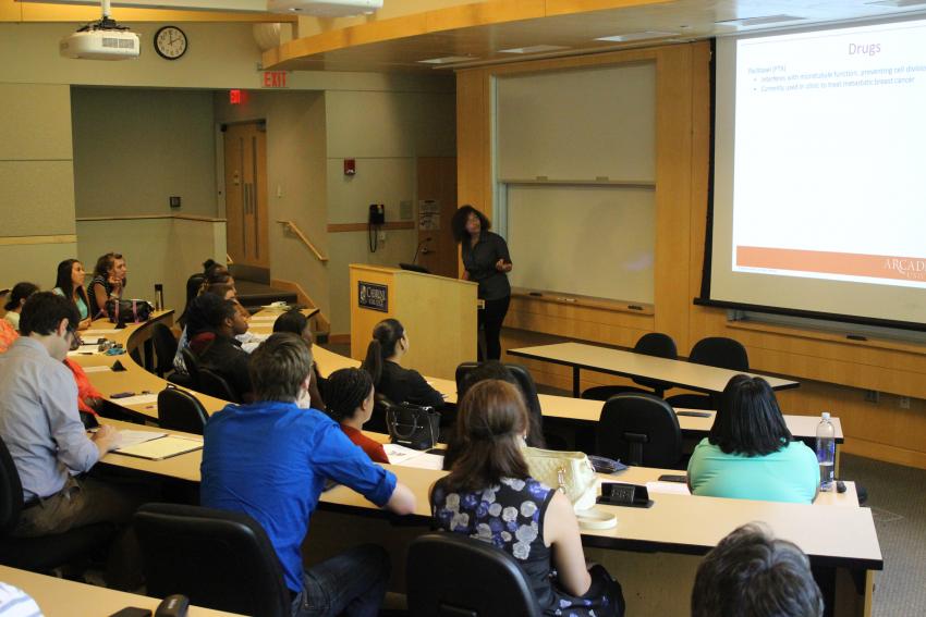 A professor teaching a group of students in a classroom