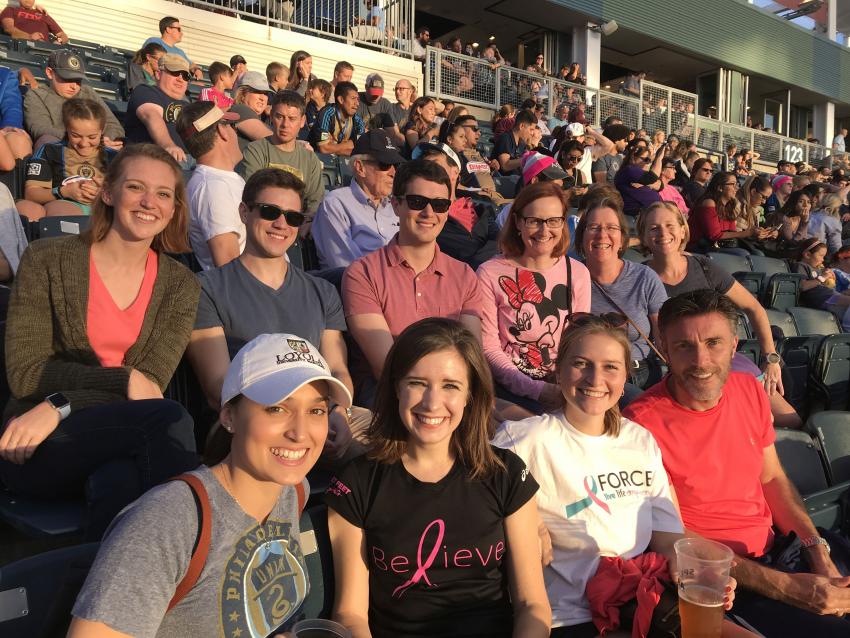 People in a stadium for breast cancer awareness.