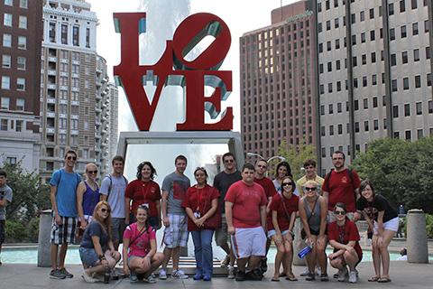 A group of Arcadia students standing in front of the Philadelphia LOVE sign