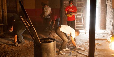 Students cleaning a basement