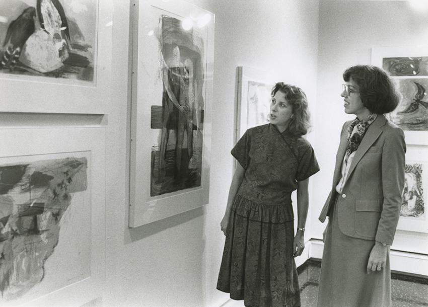 Black and white image of two women observing the Beaver College Art Gallery.