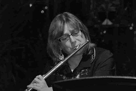 white female playing the flute