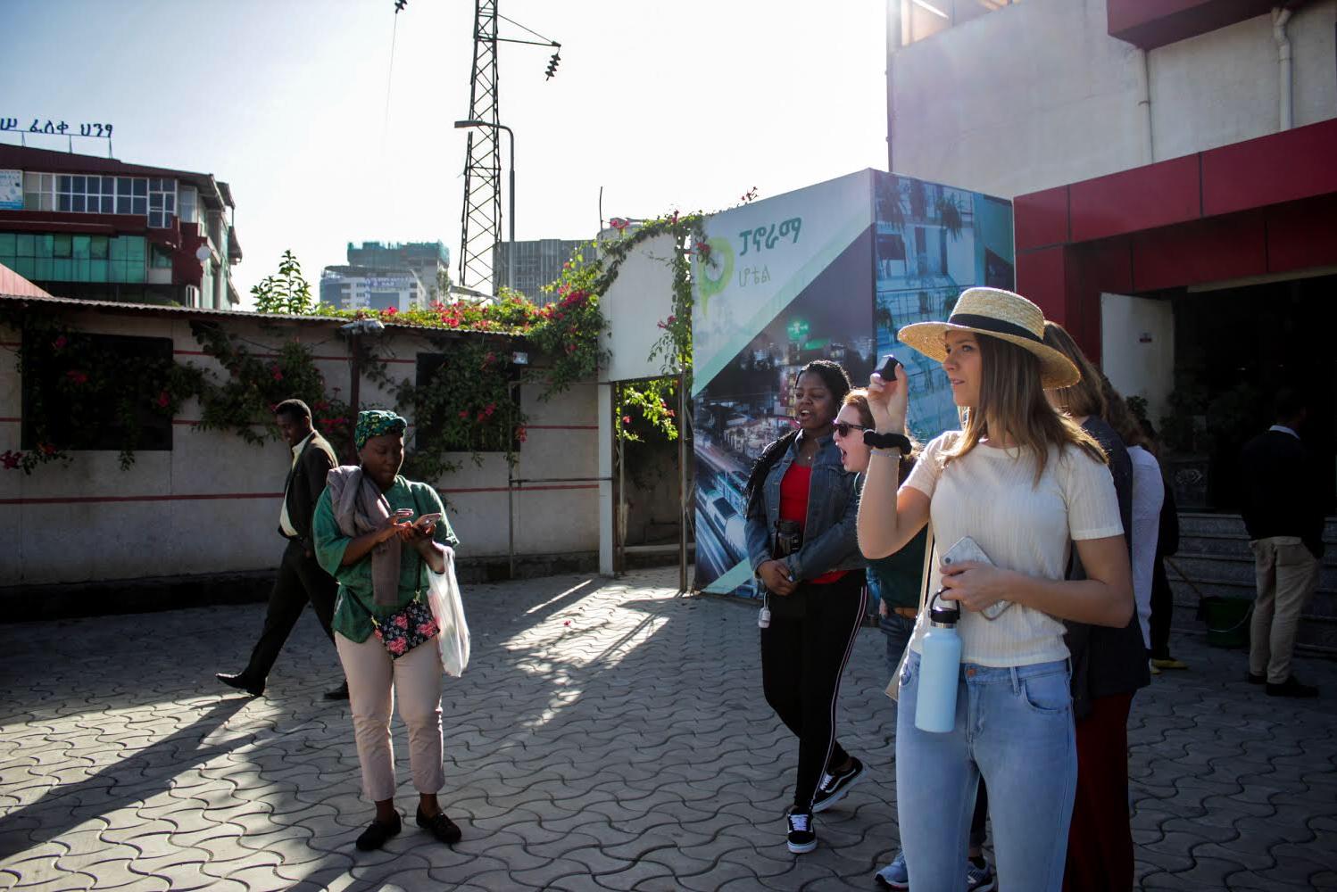 A student poses with local people while visiting abroad.