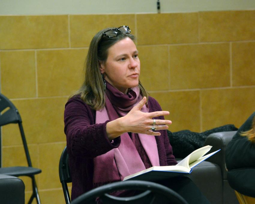 Dr. Riggan seated with a book in her lap.