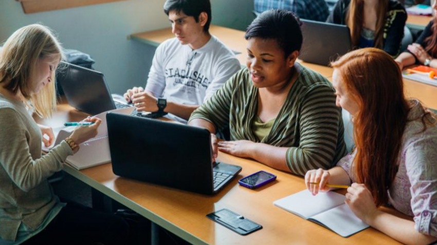 A group of people using laptops