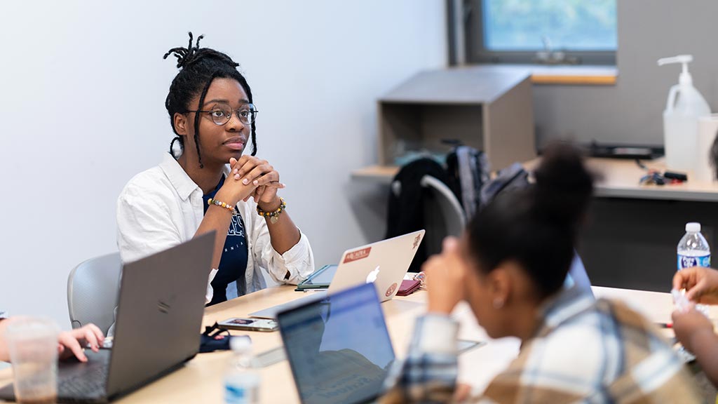 An International Relations, Diplomacy, and Law Major undergraduate student listens closely to a class lecture.