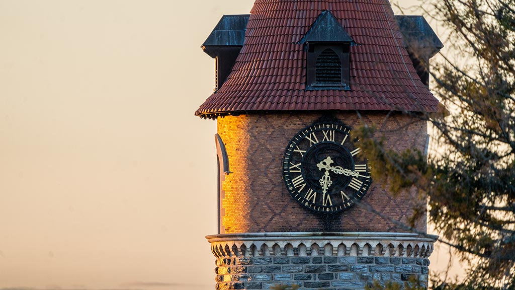 The clock tower on campus at the break of day.