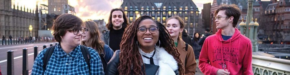 A group of students in London walking down a city street