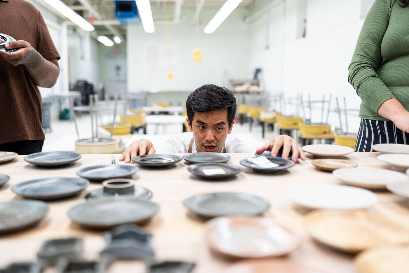 Executive Chef Hoon Rhee studies students' plateware