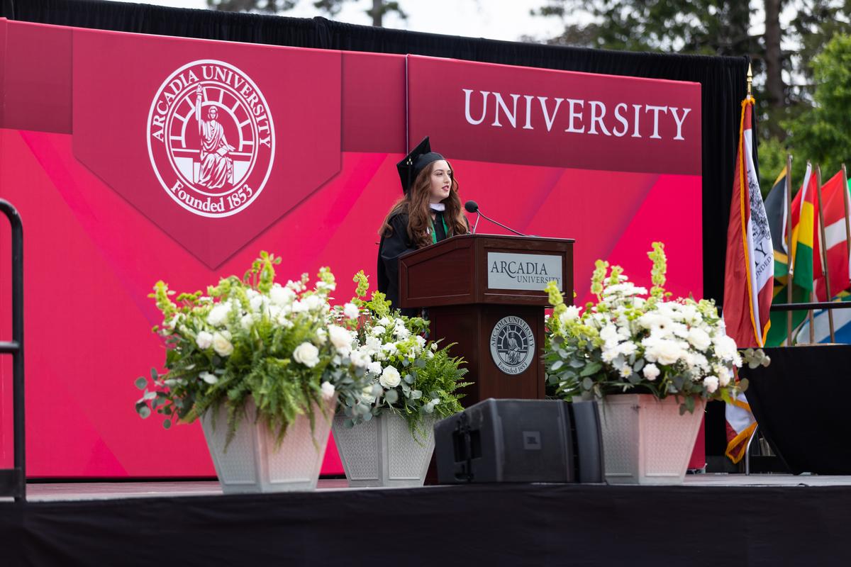 The student speaker talks on the stage at graduation